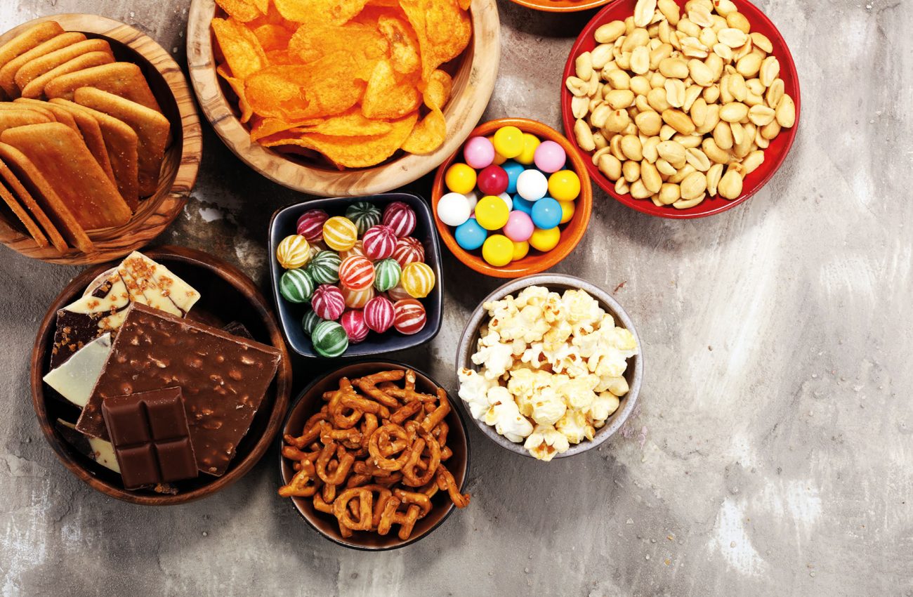 Salty snacks. Pretzels, chips, crackers in wooden bowls.