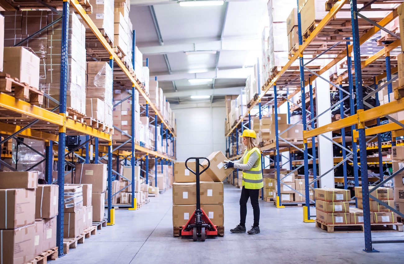 Female warehouse worker loading boxes.