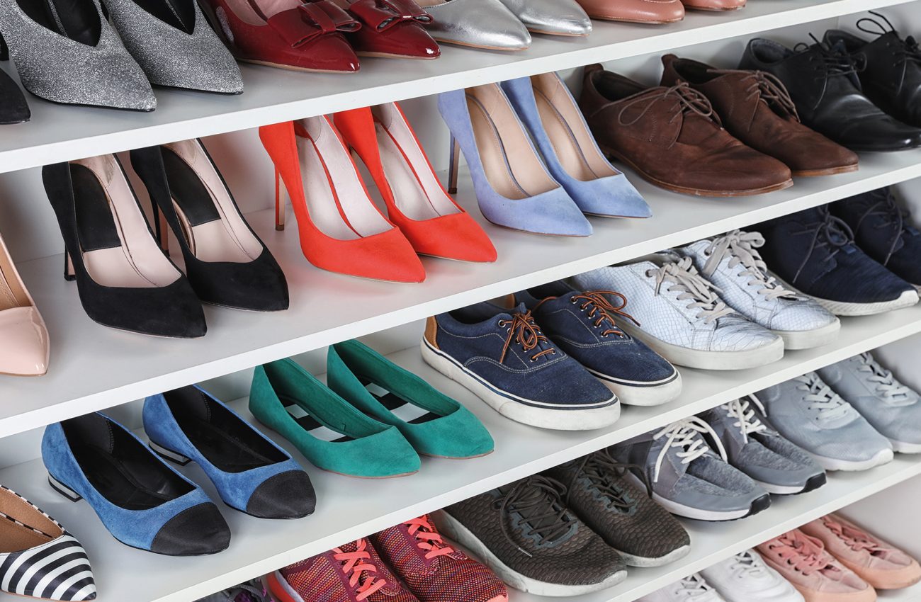 Shelving unit with different shoes. Element of dressing room int