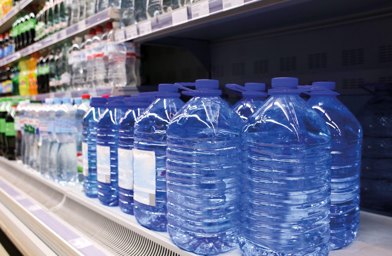 Bottles of water on shelf at supermarket