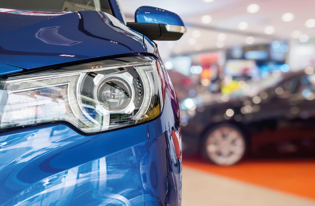 new cars in dealer showroom interior background